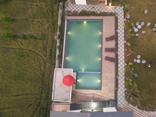 an overhead view of a swimming pool with a red ball at The Forest By 3Tree Group in Rāmnagar