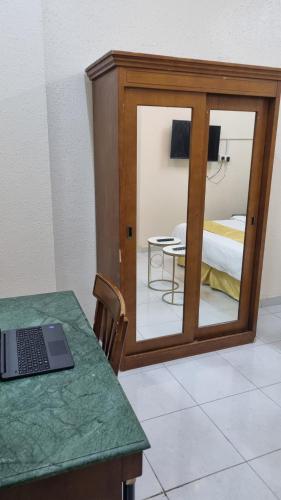 a room with a table with a laptop on a table at Welcom medina in Al ‘Awālī