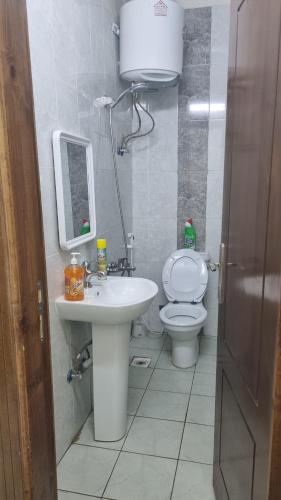 a bathroom with a sink and a toilet at Welcom medina in Al ‘Awālī