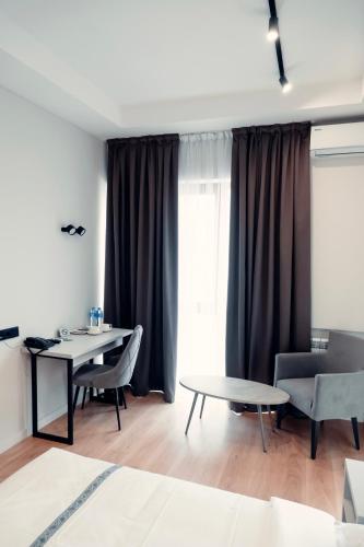 a living room with a table and two chairs and a table at Green Hill in Almaty