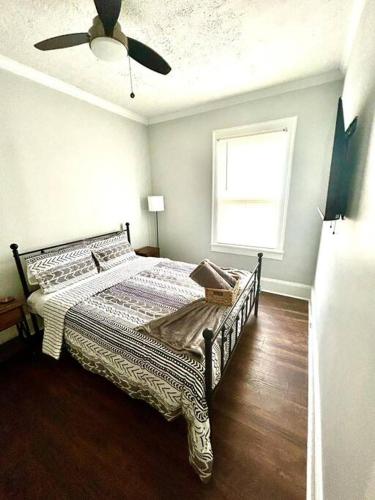 a bedroom with a bed and a ceiling fan at Downtown Charm, 3 Bdr, Near Rest and Bars in Winston-Salem