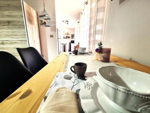 a wooden table with a bowl on top of it at Arborea Studio Apartment in Porto Torres