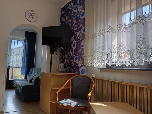 a living room with a couch and a chair at Ośrodek Wypoczynkowy Zapalenica in Szczyrk
