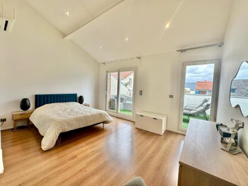 a bedroom with a bed and a large window at Luxurious Loft - Alfortville in Alfortville