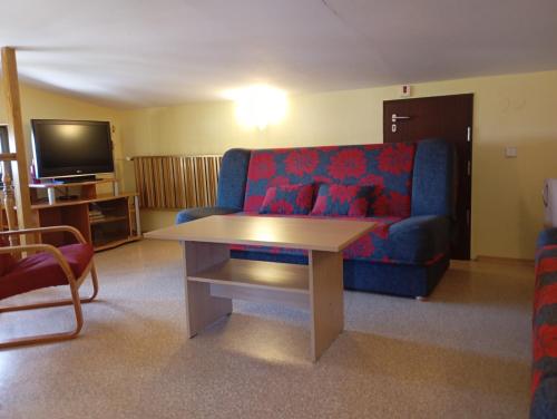 a living room with a blue couch and a table at Ośrodek Wypoczynkowy Zapalenica in Szczyrk