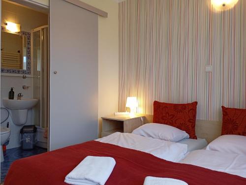 a hotel room with two beds with red and white sheets at Ośrodek Wypoczynkowy Zapalenica in Szczyrk