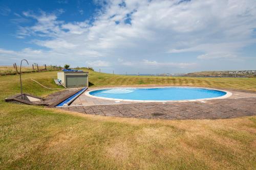 a small pool in the middle of a field at 2 Ocean's Edge in Hope-Cove