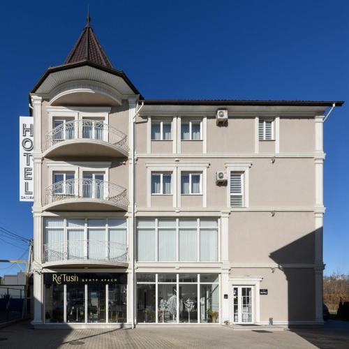 a large white building with a turret at Sagora Hotel in Chernivtsi