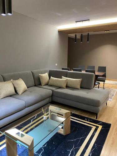 a living room with a couch and a table at DiMarla Apartment in Tirana