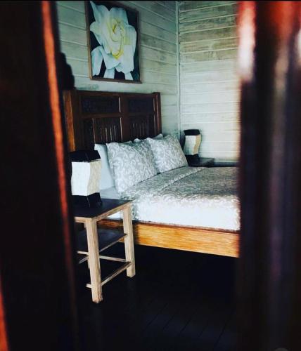 a bedroom with a bed and a chair in it at Imaj Private Villas in Senggigi 