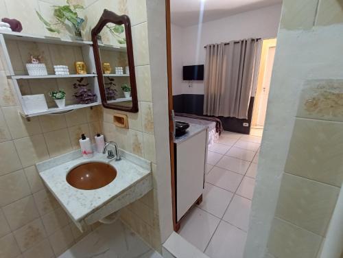 y baño con lavabo, espejo y ducha. en Refugio Piratininga térreo 102, en Niterói