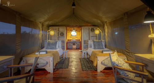 a room with two beds in a tent at Mara Major Camp in Masai Mara