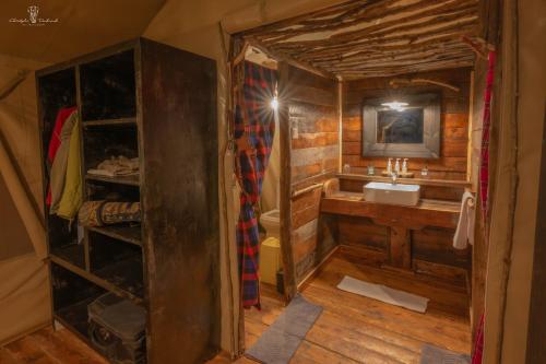 a small bathroom with a sink and a mirror at Mara Major Camp in Masai Mara