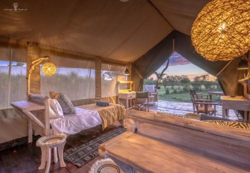 a bedroom with a bed in a tent at Mara Major Camp in Masai Mara