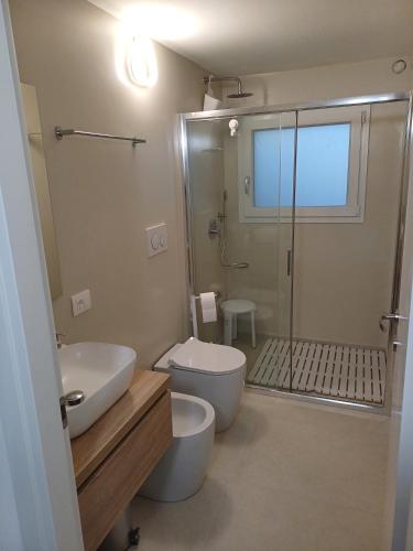 a bathroom with a toilet and a sink and a shower at Casa Vacanze Derby Appartamenti in Misano Adriatico