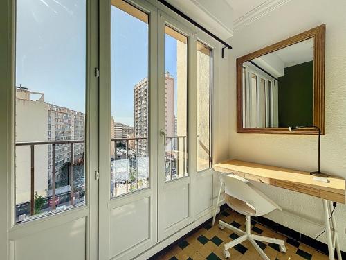 a room with a desk and windows with a view at Appartement 8 Couchages - Central & Spacieux - Les Frères de la Loc' in Marseille