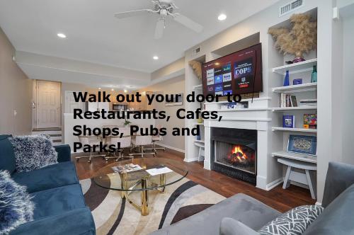 a living room with a fireplace and a tv at Lux Townhouse, Walk to All, Sleeps 6 Adults in Louisville
