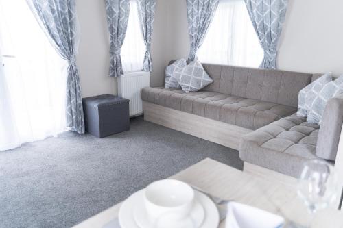 a living room with a couch and a table at Marine Holiday Park in Rhyl