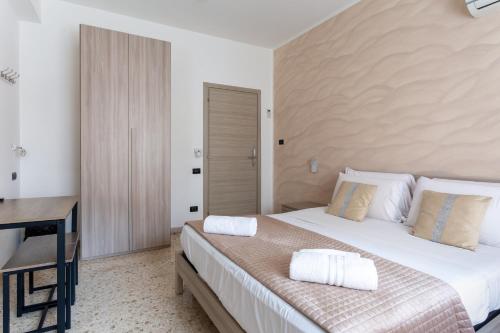 a bedroom with a large bed and a desk at Napoli Fly Guest House 290 in Naples