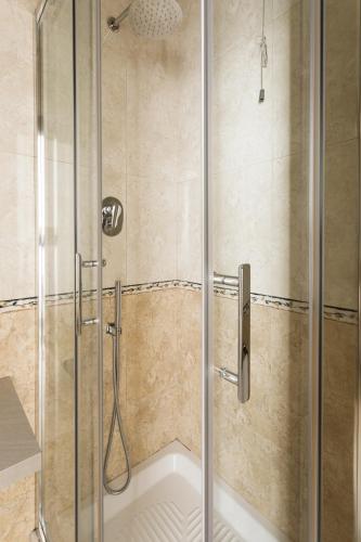 a shower with a glass door in a bathroom at Glam Luxury Rome in Rome