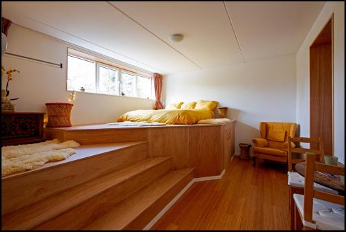 a bedroom with a bed on top of a wooden floor at Michaelsark in Amsterdam