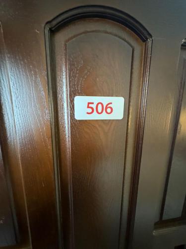 a sign that says on a wooden door at Hotel Grbalj in Budva