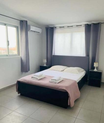 a bedroom with a large bed with two towels on it at Residencial Sao Miguel in Calheta de São Miguel