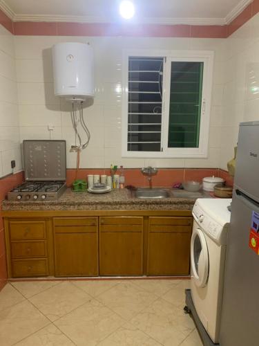 a kitchen with a sink and a stove top oven at Appartement a loué fes in Fès