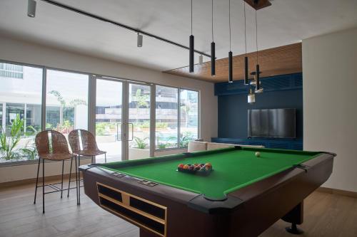 a living room with a pool table in a room at Brandons at the Pavilion Cantonments in Accra
