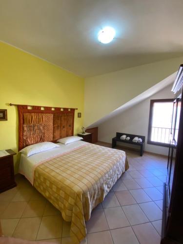 a bedroom with a bed and a yellow wall at Le tre terrazze - Gallipoli in Gallipoli