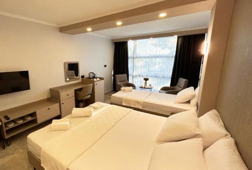 a hotel room with two beds and a television at 01 Nova Otel in Didim