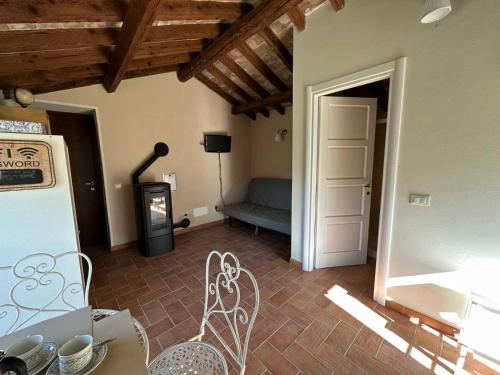 a living room with a couch and a table and chairs at Oltrella Country House in Ponte Nizza