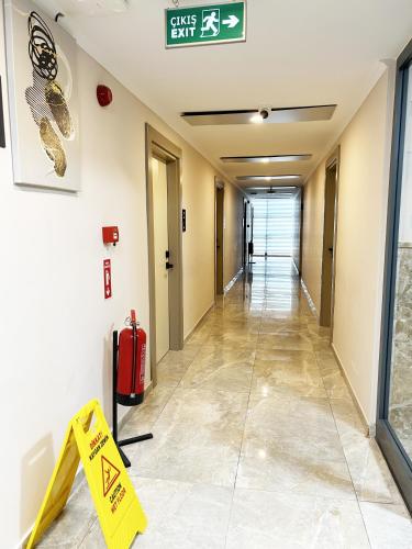an empty hallway in a building with a sign on the wall at 01 Nova Otel in Didim