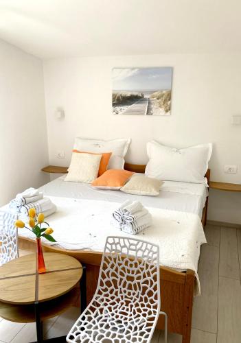 a bedroom with a bed and a table and chairs at Levanda in Trogir