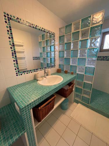 a bathroom with a sink and a mirror at chambre St Malo Cancale in Saint-Méloir-des-Ondes