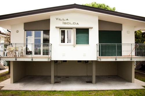 Una casa blanca con 2 balcones. en Villa Isolda: moderno trilocale, en Bibione
