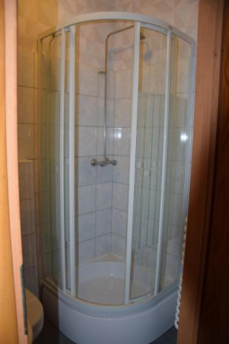 a shower with a glass door in a bathroom at Noclegi Viktor in Kalwaria Zebrzydowska