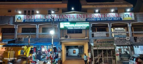 a building with a sign that reads hotel central american americana at hotel chaitanya international in Puttaparthi