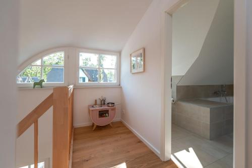an attic hallway with a staircase and a window at Ferienhaus Nordstern in Zirchow
