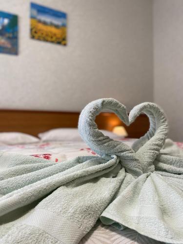 a towel in the shape of a heart on a bed at Ca' Del Diaolo in Badia Calavena