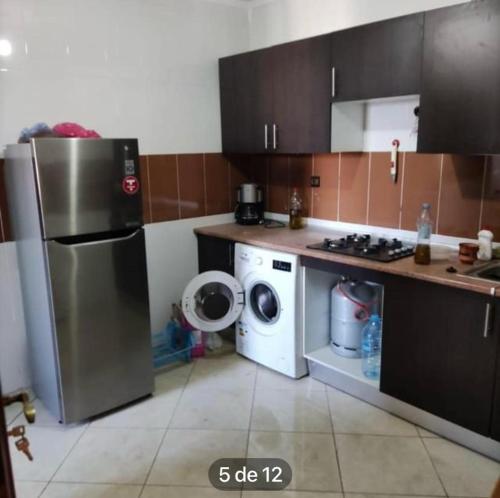 a kitchen with a refrigerator and a washing machine at val fleuri résidences Tanger in Tangier