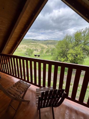 a balcony with a bench and a view of a field at Brvnara Nina in Kremna