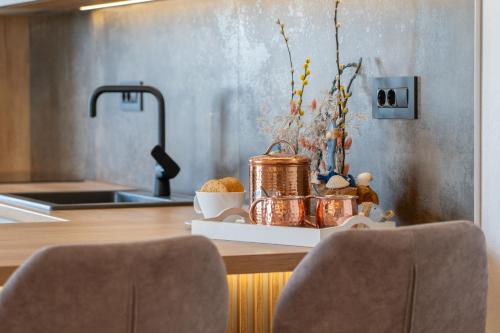a kitchen counter with a tray with flowers and a sink at Apartman L&L in Makarska