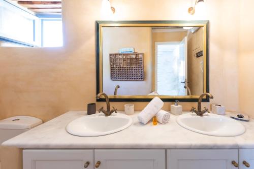 a bathroom with two sinks and a mirror at Marpissa Paros house Casa Mira in Kampos Paros