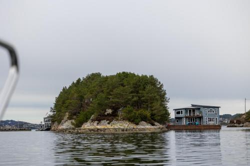 a house on an island in the water at Floating Villa Bergen in Bergen