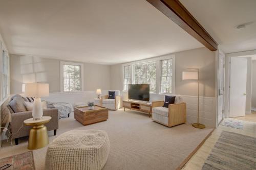 a large living room with a bed and a television at Short walk to Bayside Beach in Eastham
