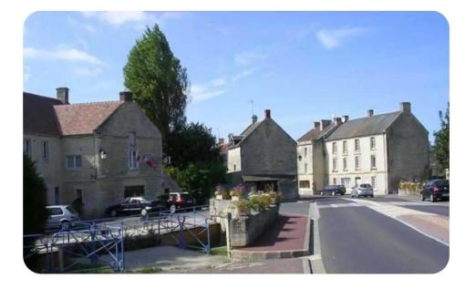 a group of houses in a town with a street at Logement cosy parking privé situé au cœur du village in Reviers