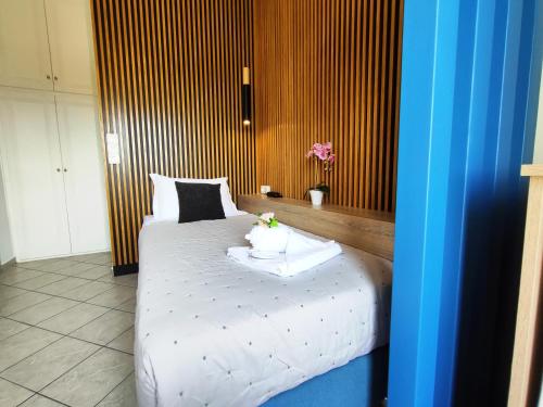 a bedroom with a white bed with flowers on it at Nemesis in Fira