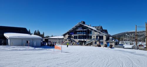 a large building on a ski slope in the snow at LEVI Tunturinlaita A4, Ski-in Ski-out 3xBedroom in Levi