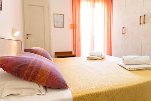 a bedroom with a bed with two pillows on it at Hotel Atlantic in Gatteo a Mare